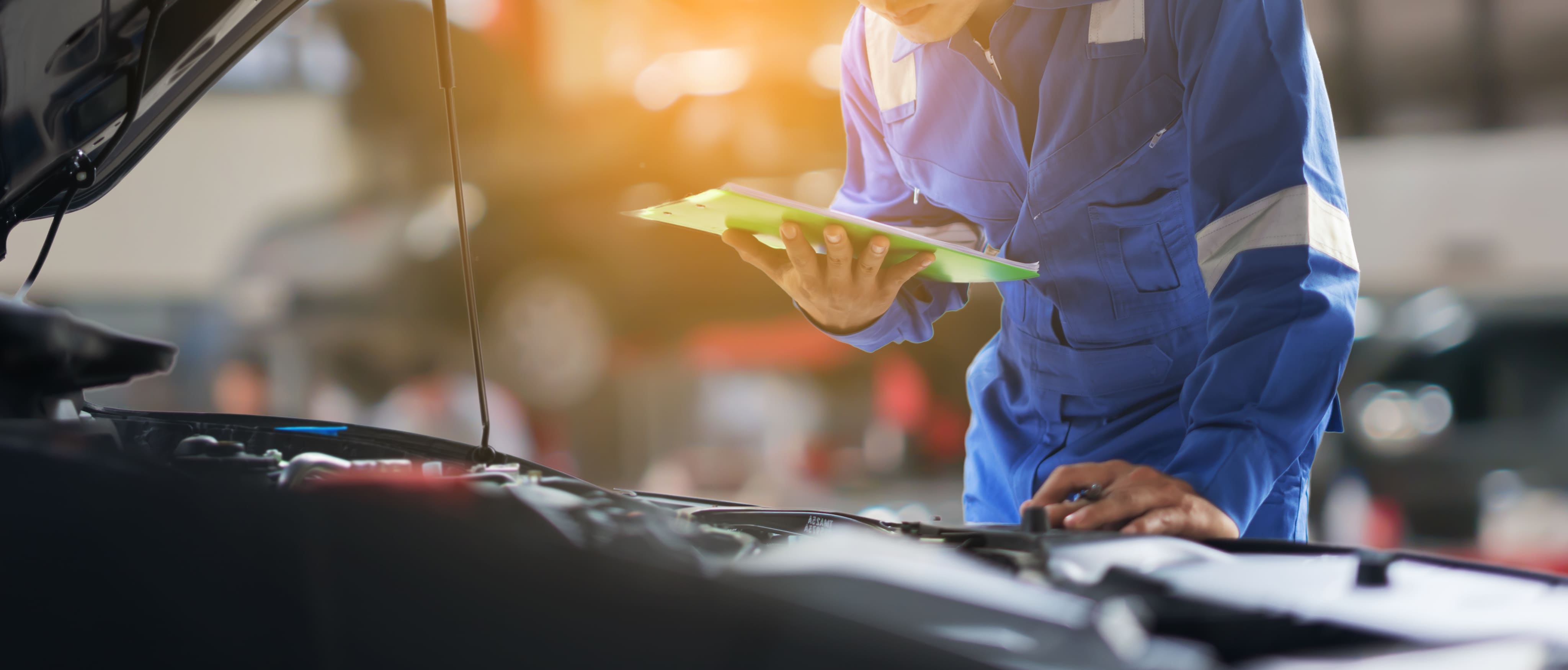 Car Mechanic Doing An Inspection Of A Vehicle